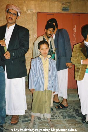 A boy insisting on getting his picture taken