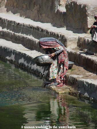 A woman washing in the water basin A woman washing in the water basin