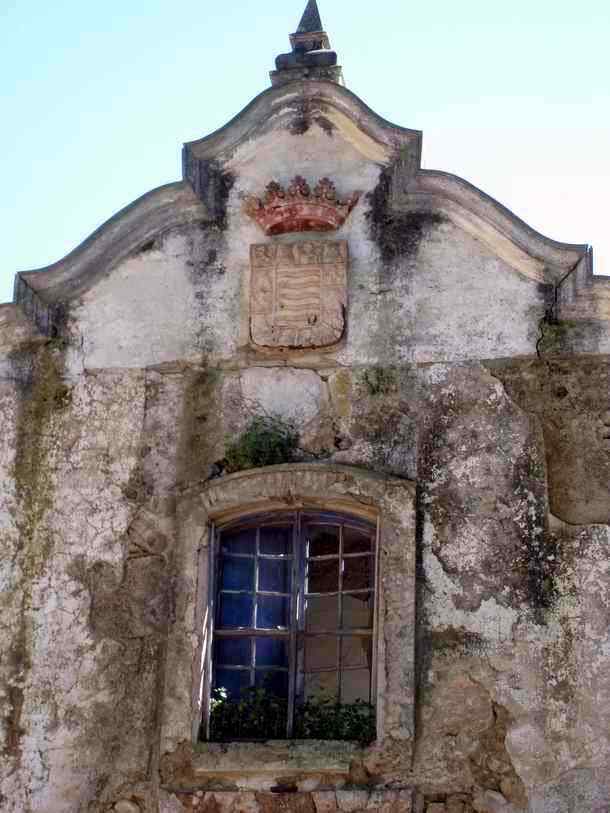 Overview of the coat of arms at the deserted stylish house near the Tempul Spring at the Guadalcacin reservoir in Andalucia-Spain