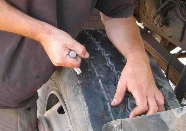 Truck tire puncture tool inside puncture with plug
